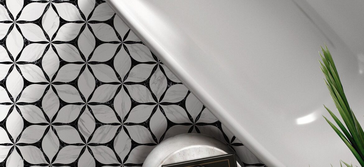 Black and white floral geometric floor tiles in a luxury bathroom with freestanding tub