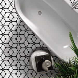 Black and white floral geometric floor tiles in a luxury bathroom with freestanding tub